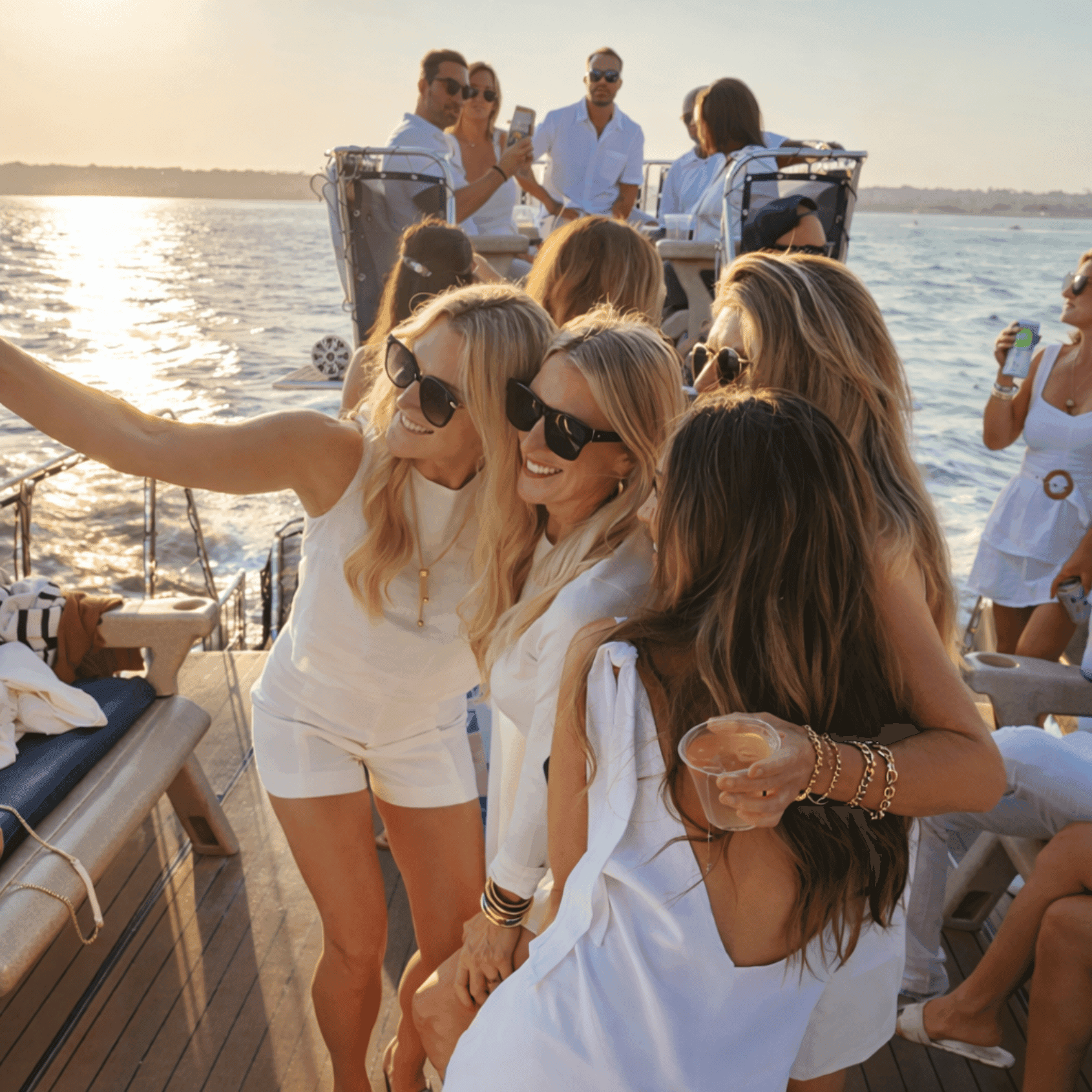 Friends taking selfie at sunset yacht party
