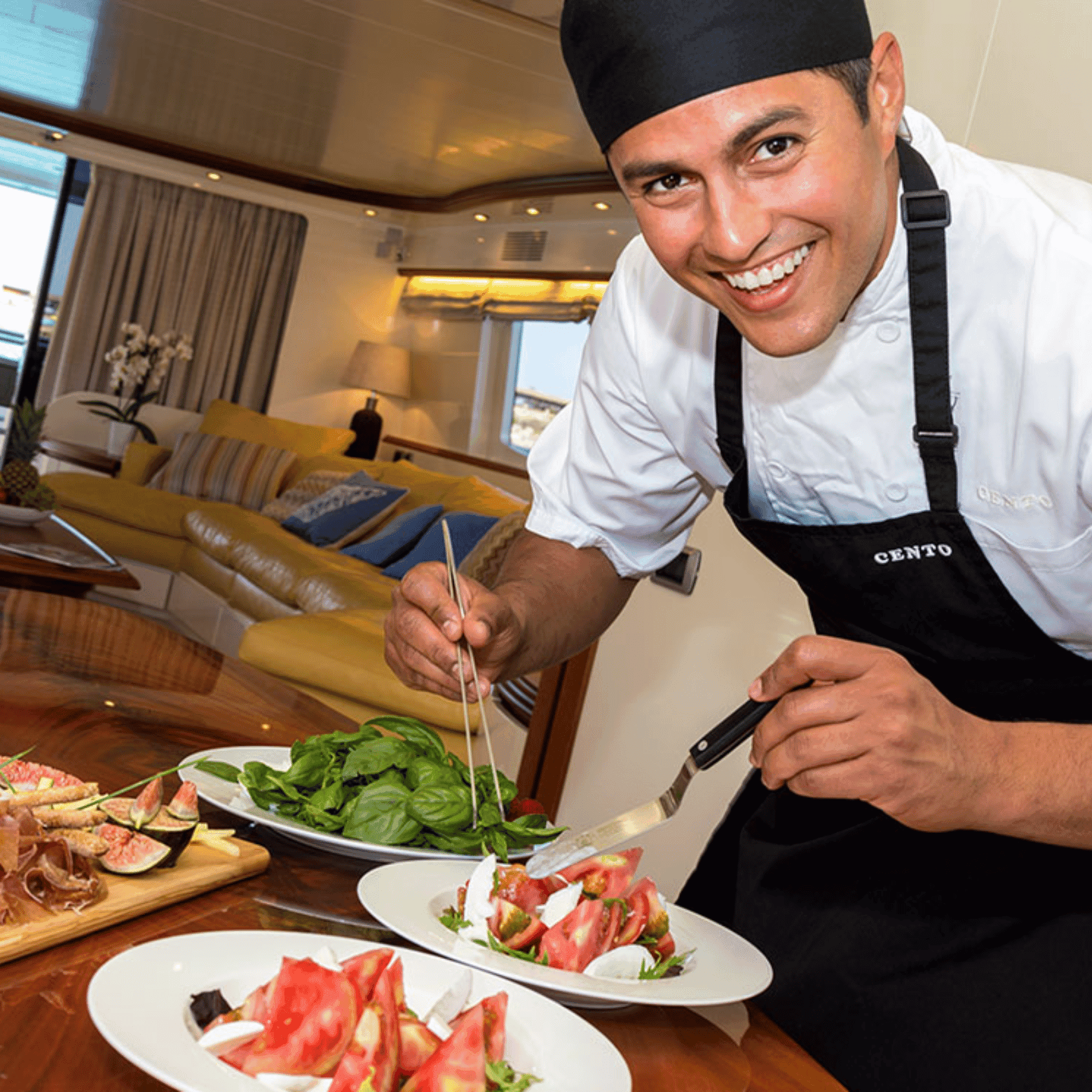 Chef preparing fresh salad on luxury yacht