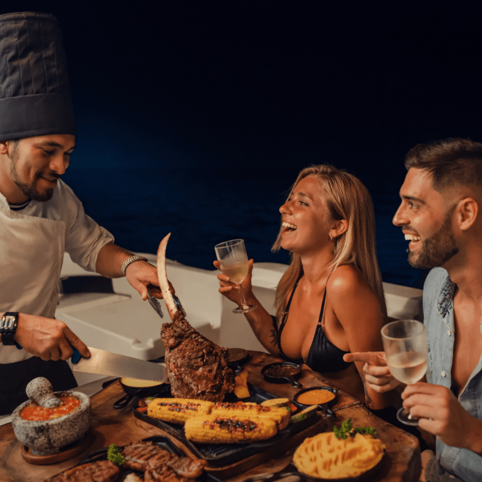 Private chef serving dinner on yacht at night