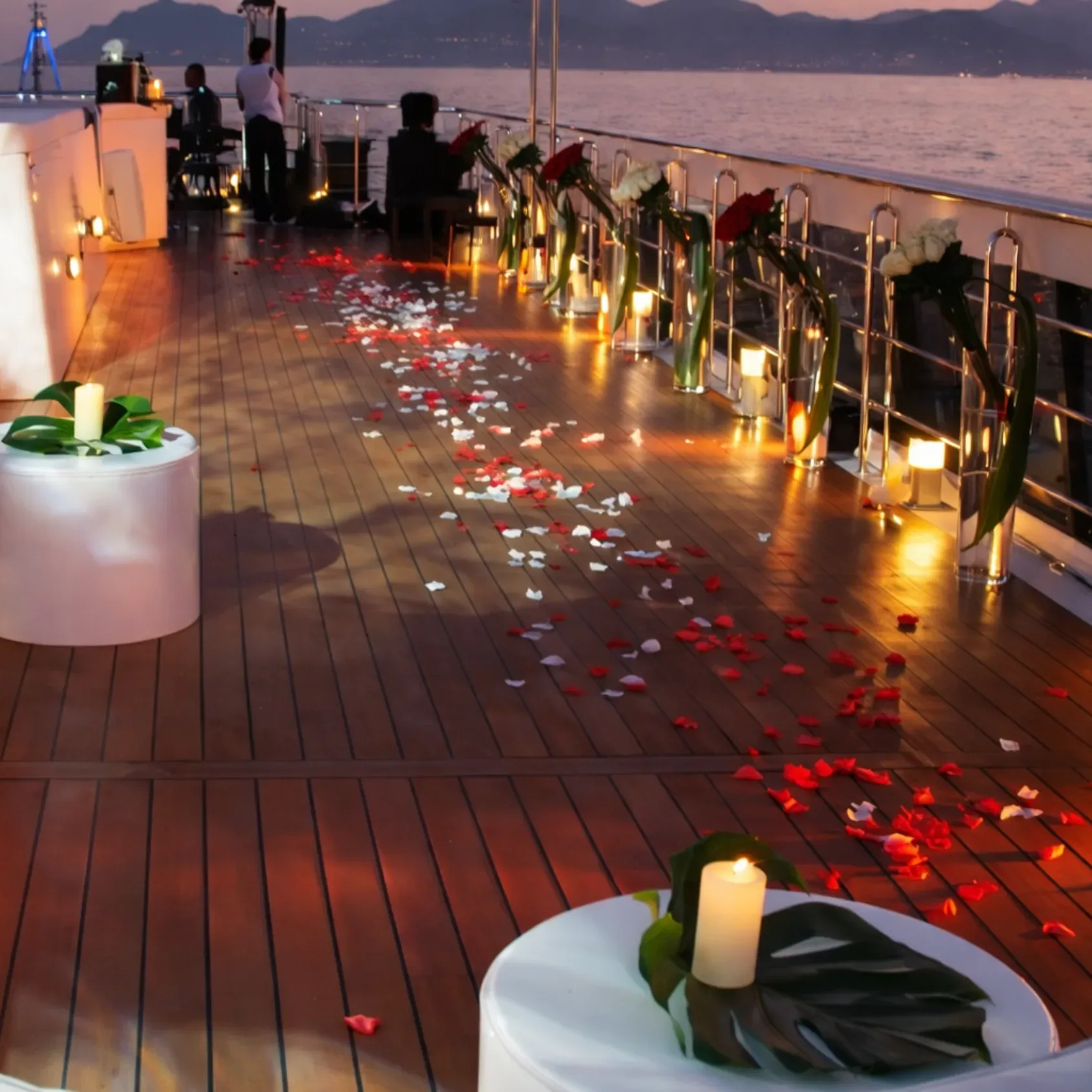 Rose petal decorated yacht deck at sunset for a Miami wedding